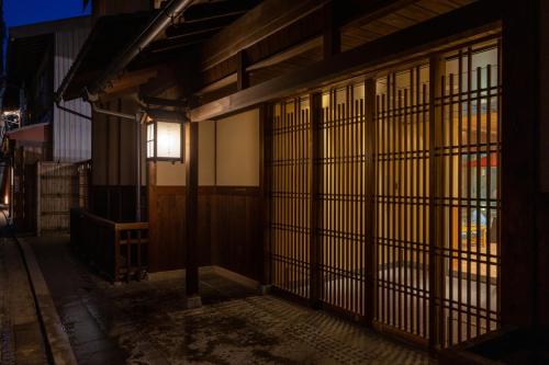 an entrance to a building at night at ibis Styles Kyoto Shijo in Kyoto