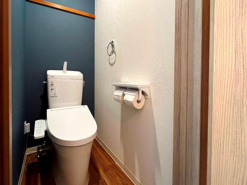 a bathroom with a white toilet in a room at Fukiya in Gero