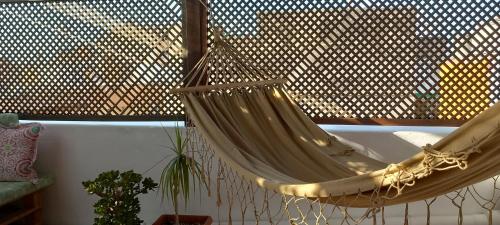 a hammock hanging from a window in a room at Salicornia terrassa in Amposta