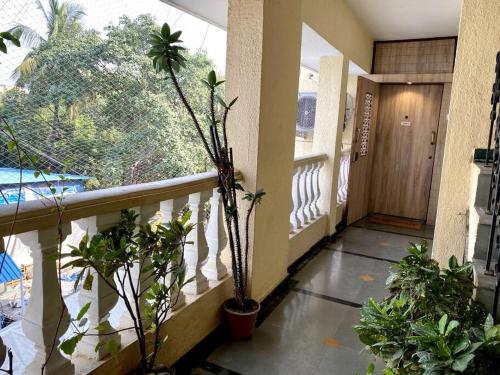 a hallway with potted plants and a balcony at Saba 301, Subko Coffee, Chapel Road, Bandra West by Connekt Homes in Mumbai