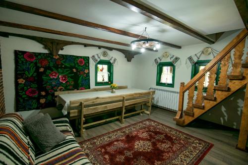 a room with a large bed and a staircase at Căsuța Doinița in Borşa