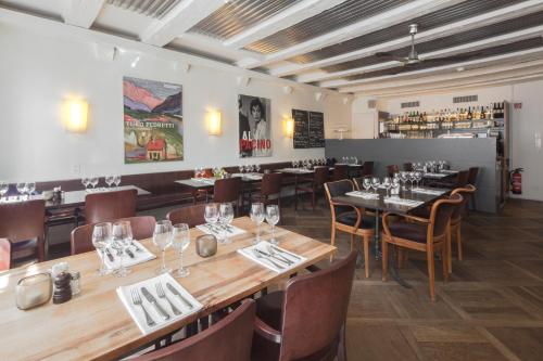 a dining room with wooden tables and chairs at Baseltor Hotel & Restaurant in Solothurn