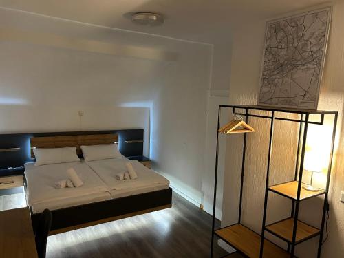 a bedroom with a bed with two pillows on it at Riverside Airport Hotel in Kelsterbach
