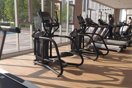 a row of exercise bikes in a gym at Alanis Residence@KLIA in Sepang