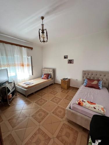 a living room with two beds and a couch at Holiday Home in Vlorë