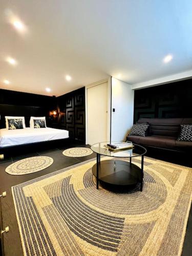 a bedroom with a bed and a table in a room at La Suite Saint Roch in Villeréal