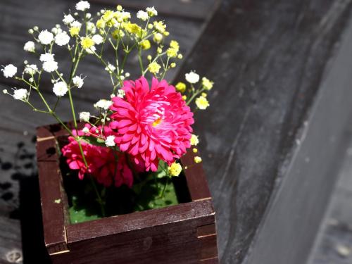 a wooden box with pink flowers in it at Fukiya in Gero