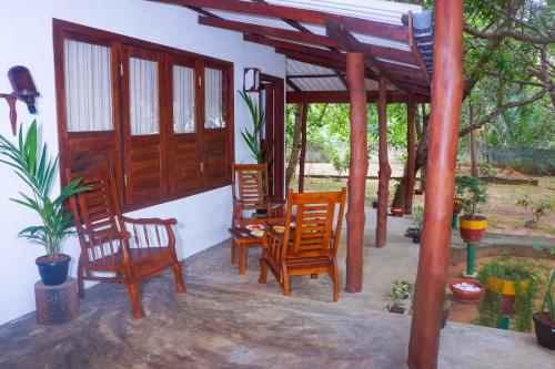 a group of chairs and a table on a patio at Flash Rock Villa in Sigiriya
