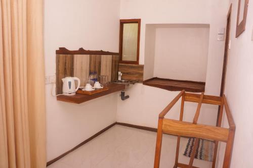 a small bathroom with a sink and a mirror at Flash Rock Villa in Sigiriya