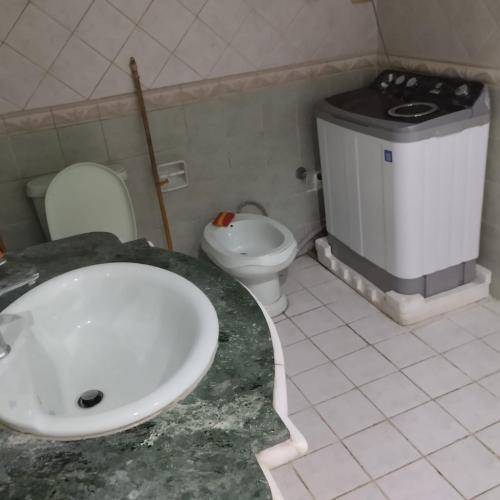 a bathroom with a sink and a toilet at شقة مفروشة سوبر لوكس للايجار in Cairo