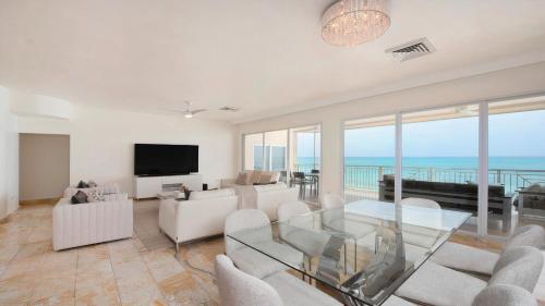 a living room with a view of the ocean at Laguna Del Mar in George Town