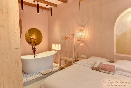 a bedroom with a bath tub and a bed at La Loge du Rêveur - Spa - Vieux-Lyon in Lyon