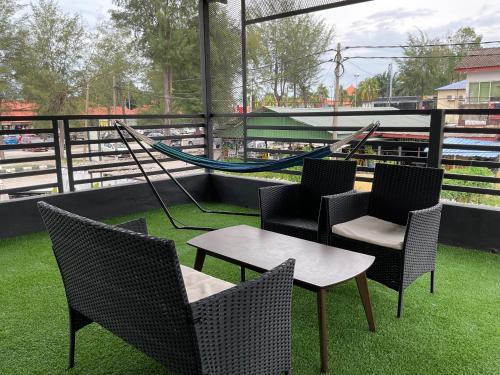 a playground with chairs and a hammock on a baseball field at The Sky Inn in Kuantan