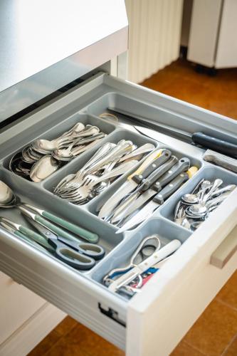 a drawer filled with utensils in a kitchen at Villa tra montagna e laghi 14 posti in Crone