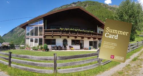 a large building with a sign in front of it at Haus am Mühlroan in Sölden