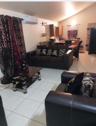 a living room with two leather couches and a table at Leila VIllage Plus in Mendes