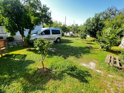 a white van parked in a yard with a small tree at Chateau Sukaj in Laknas