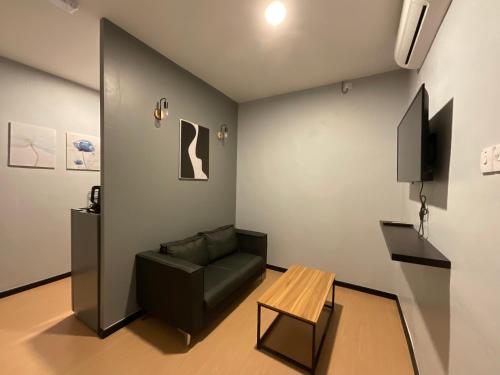 a living room with a couch and a table at The Sky Inn in Kuantan