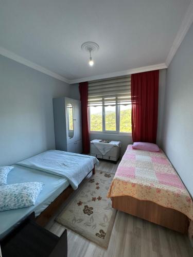 a bedroom with two beds and a window at Xudisa Manzaram in Pazar