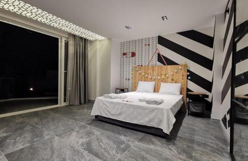 a bedroom with a bed and a large window at Exquisite Villa with Private Pool in Antalya in Belek