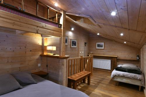 ヴァロルシーヌにあるLes Posettes, appartement Le Sizeray - Mont Blancのログキャビンベッドルーム(ベッド1台、ベンチ付)
