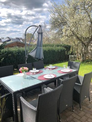 an outdoor table with chairs and a lamp at Ferienwohnung Eifel-Roedis in Blankenheim