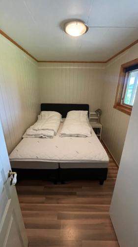 a bedroom with a bed in a small room at EG Apartment in Leknes