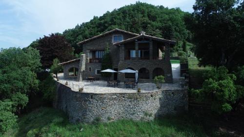 a house on top of a stone wall at Santa Llúcia Rupit in Rupit