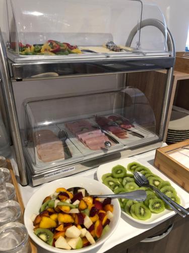 a refrigerator with a plate of vegetables and meat at Šangulin Palace V in Biograd na Moru