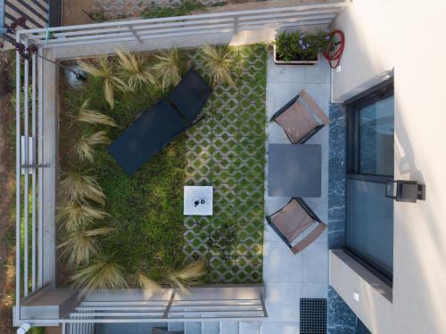 an overhead view of a garden on the side of a building at Isida - cozy sea walk lodge with private garden in Nea Makri