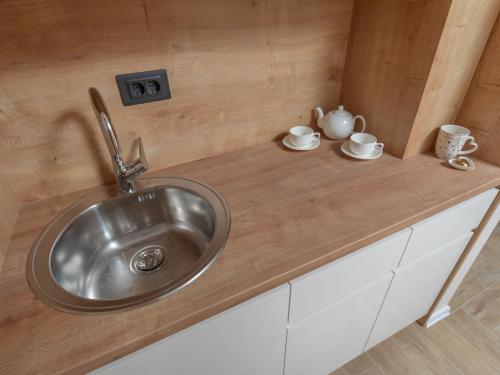 a kitchen sink with two cups and saucers on it at Hotel Diman in Dobra Voda