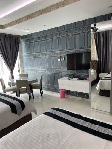 a hotel room with two beds and a dining room at Rumah Cik Ani in Shah Alam