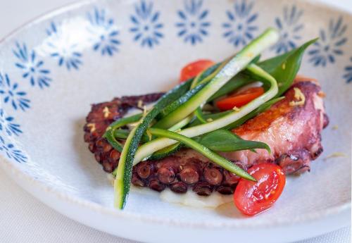 a plate of food with meat and vegetables on it at Hotel Villa Mabapa in Venice-Lido
