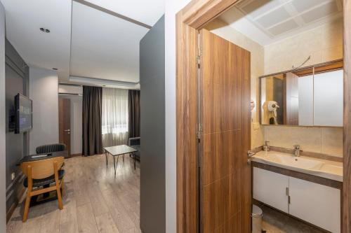 a bathroom with a sink and a mirror at Comfort Suites Hotel in Istanbul