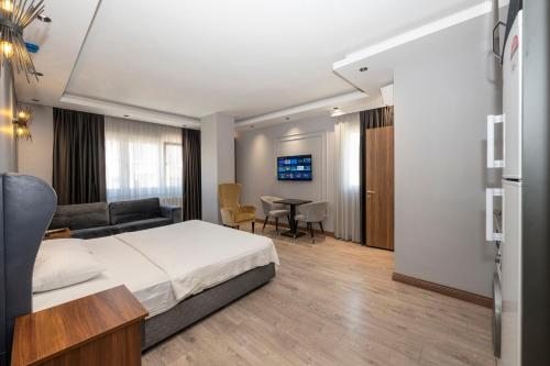 een slaapkamer met een bed, een bank en een tafel bij Comfort Suites Hotel in Istanbul