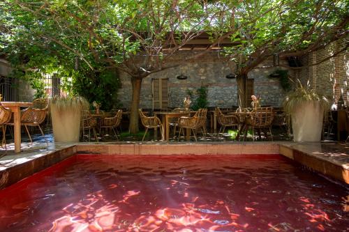 a koi pond in front of a restaurant at Life Gallery Hotel & Spa in Korçë