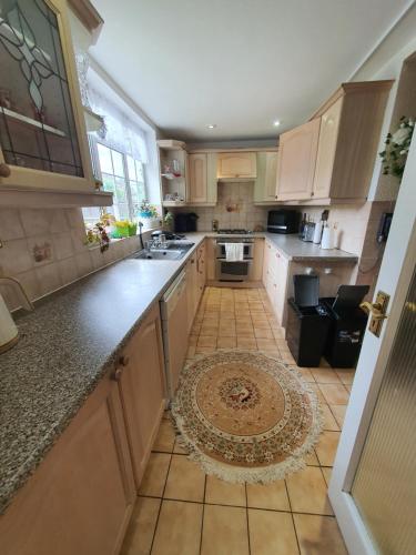 a kitchen with wooden cabinets and a tile floor at ELaparty in Stone Grove