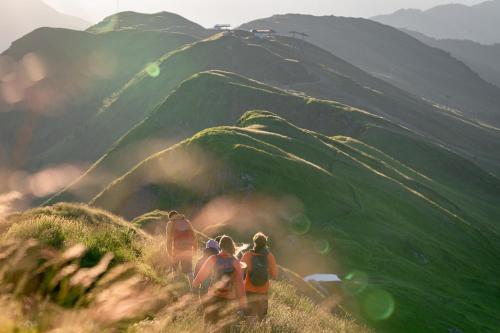 a group of people walking up a mountain at PHILSON Apartments in Saalbach Hinterglemm