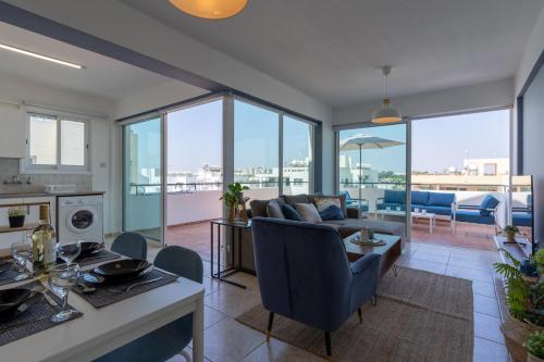 a living room with a couch and a table at Chloris 3- Bedroom Apartment W/Pool in Larnaca in Larnaca