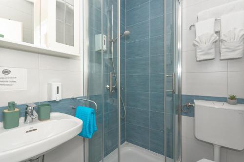 a bathroom with a shower and a sink at Pansion Pirat in Petrcane