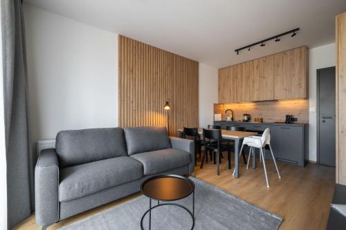 ein Wohnzimmer mit einem Sofa und einem Tisch in der Unterkunft Apartmány Florián in Kvilda