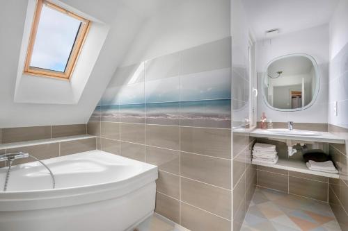 een badkamer met een wastafel, een toilet en een spiegel bij Instants de repos et de detente a Sarzeau in Sarzeau