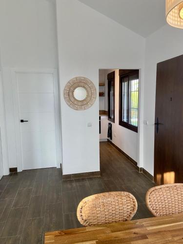 a living room with two chairs and a door at Vela Luka Frigiliana in Frigiliana