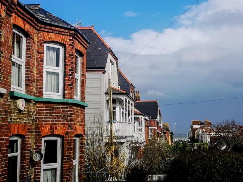 a row of brick houses on a city street at Cliff Cottage with private garden - Broadstairs in Kent