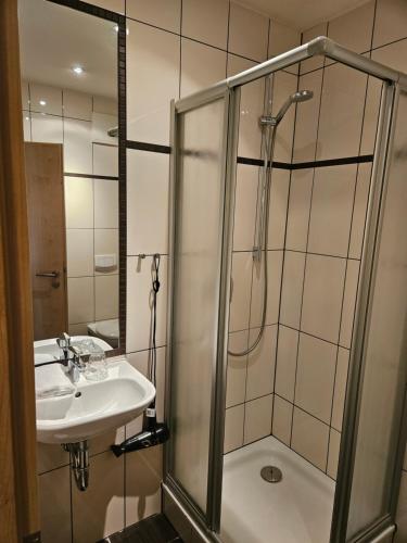 a bathroom with a shower and a sink at Hafen 17 Hotel Küche Bar in Kehl am Rhein