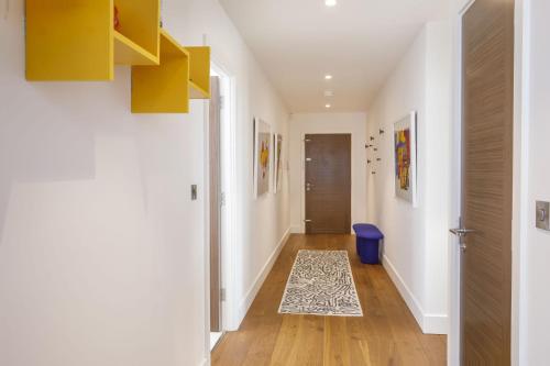 a hallway with a door and a rug on the floor at Clifford's Skyline in York