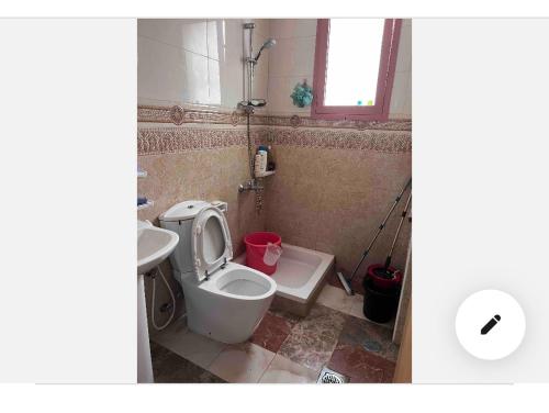 a bathroom with a toilet and a sink at Najm home in Ajman 