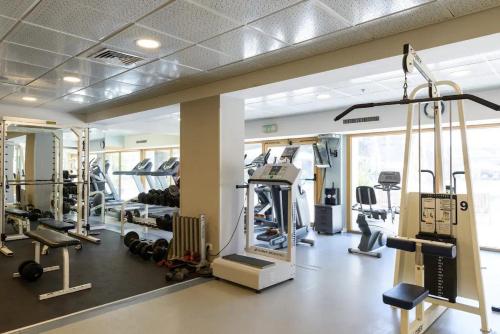 a gym with several treadmills and machines at ANDRO LUX 2BR apartment with pool in Old Jaffa in Tel Aviv