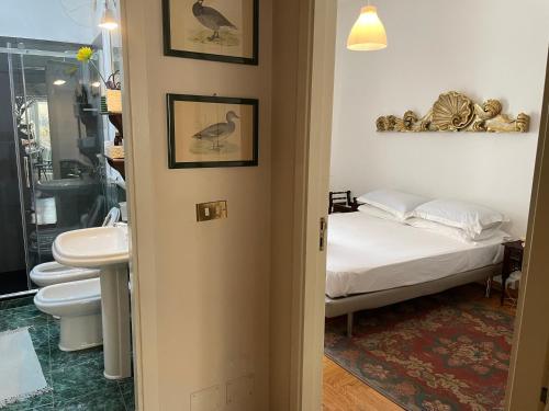 a bathroom with a bed and a toilet and a sink at Da Cristina Palazzo Atanasio in Palermo