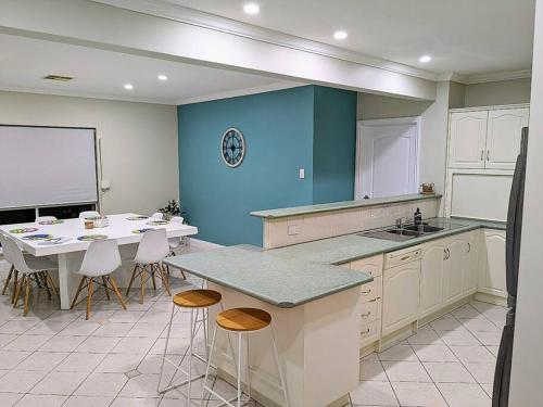 a kitchen with a table and some chairs and a counter at Holli-daze on Coast Moonta Bay in Port Moonta